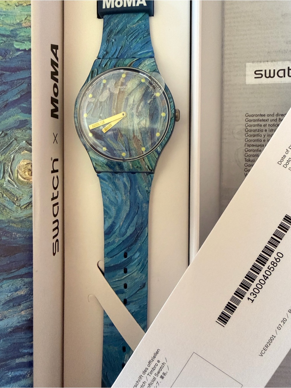 Swatch blue marbled dial and strap watch with yellow hands